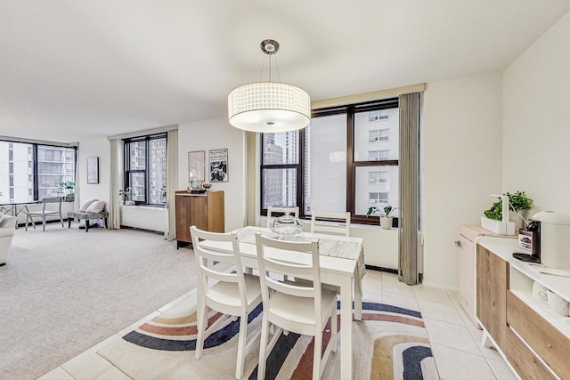 dining space featuring light colored carpet