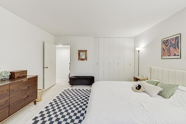 bedroom featuring radiator heating unit and light carpet