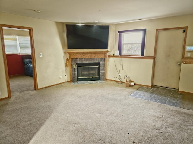 unfurnished living room with carpet floors and a fireplace