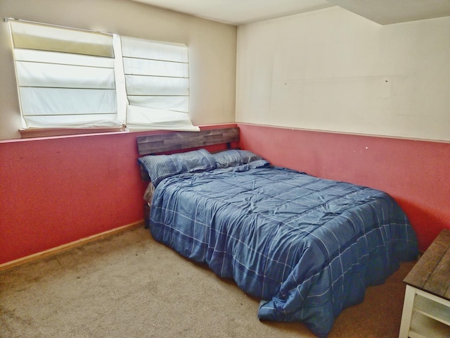 bedroom featuring multiple windows, baseboards, and carpet