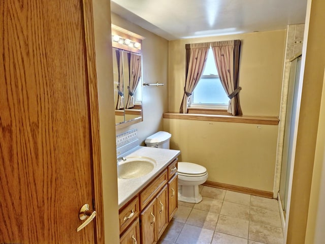 full bathroom with baseboards, toilet, a stall shower, tile patterned floors, and vanity