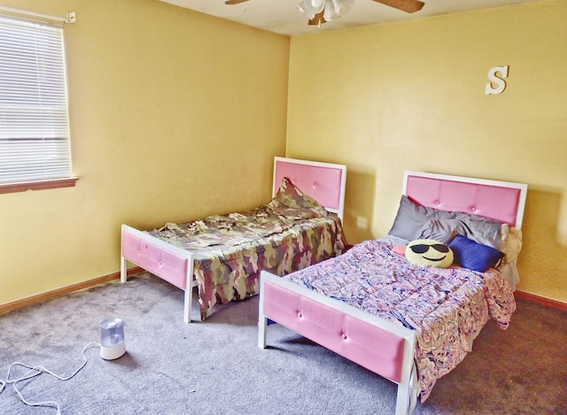 bedroom with baseboards, multiple windows, a ceiling fan, and carpet flooring