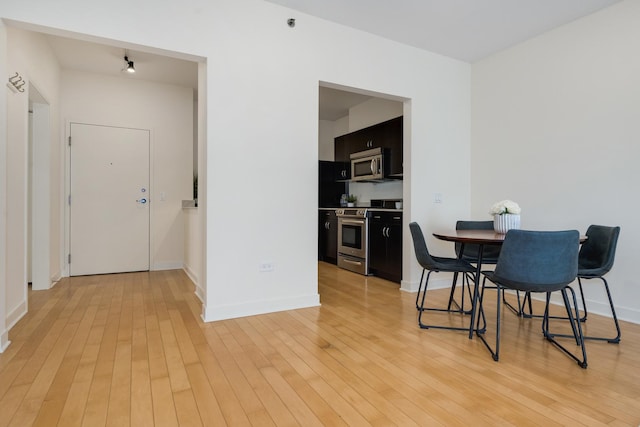 dining space with light hardwood / wood-style floors