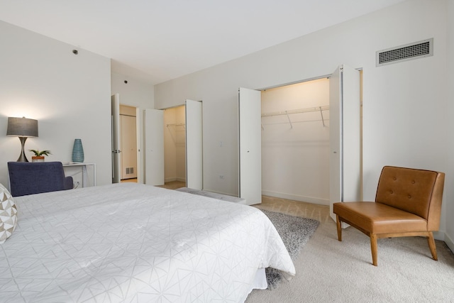 bedroom featuring multiple closets and carpet