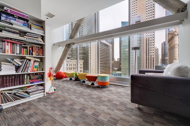 game room featuring a wealth of natural light, carpet floors, and a high ceiling