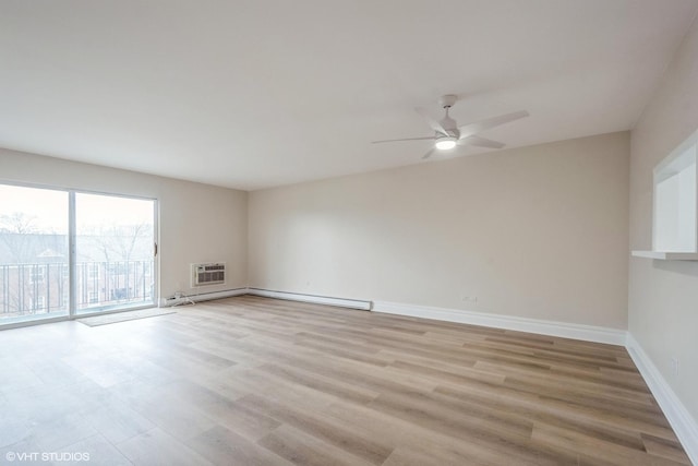 unfurnished room with ceiling fan, a baseboard radiator, a wall mounted AC, and light hardwood / wood-style floors