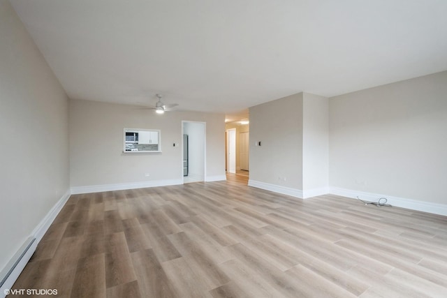 unfurnished living room featuring ceiling fan, light hardwood / wood-style floors, and a baseboard heating unit