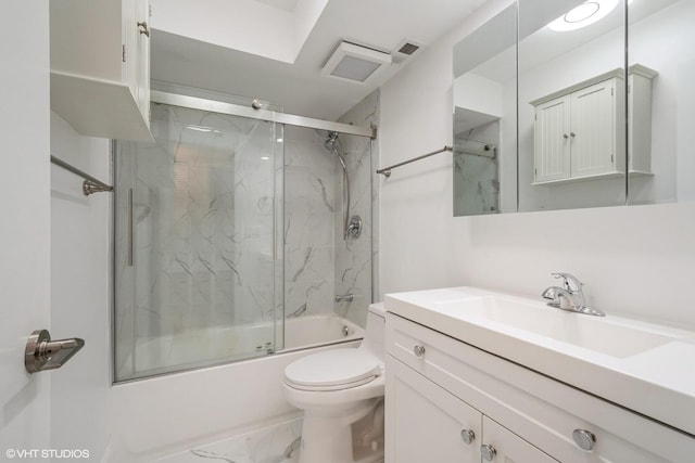 full bathroom featuring vanity, combined bath / shower with glass door, and toilet