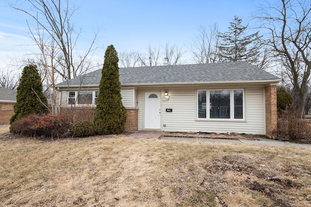 ranch-style home with a front lawn