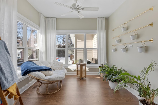 living area featuring dark wood-style floors, visible vents, ceiling fan, and baseboards