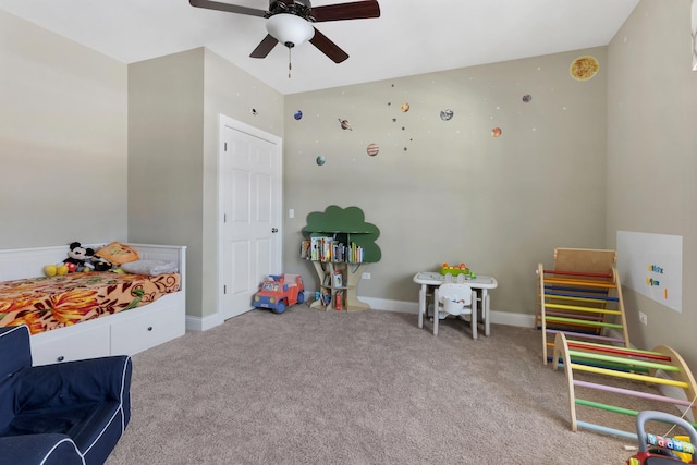 rec room with baseboards, ceiling fan, and light colored carpet