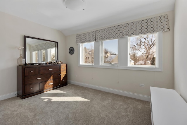 bedroom with multiple windows, baseboards, and light colored carpet