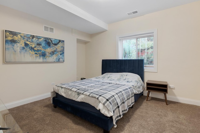 carpeted bedroom featuring visible vents and baseboards