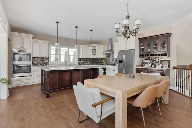 dining area with a notable chandelier and wood finished floors