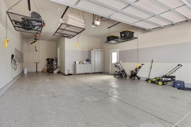 garage featuring a garage door opener and baseboards