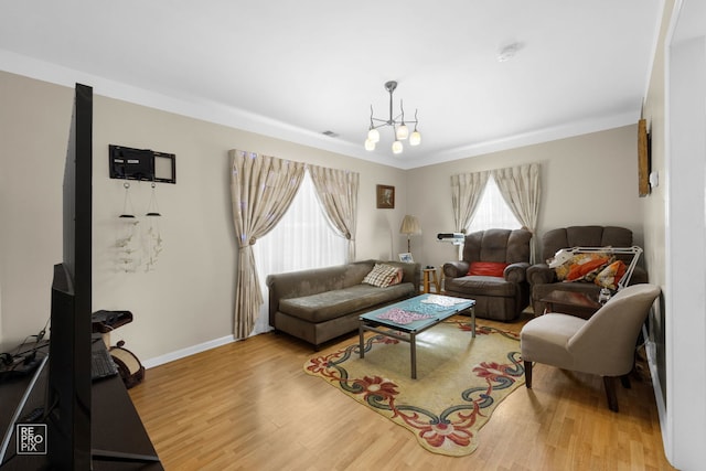 living room with an inviting chandelier and wood-type flooring