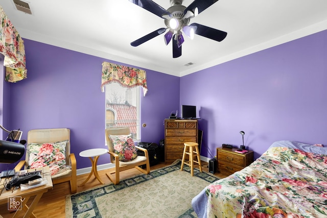 bedroom featuring hardwood / wood-style flooring and ceiling fan