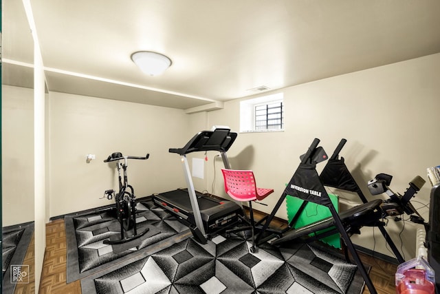 exercise area featuring parquet floors