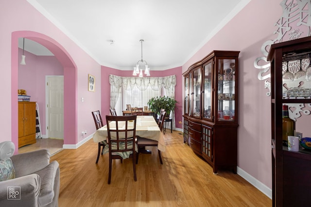 dining room featuring ornamental molding and light wood-type flooring