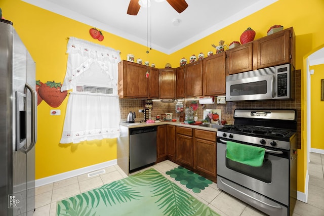 kitchen with backsplash, stainless steel appliances, ceiling fan, and light tile patterned flooring