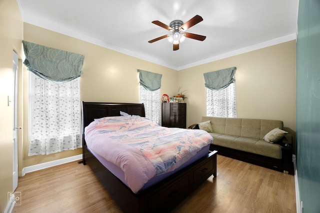 bedroom with light hardwood / wood-style floors and ceiling fan