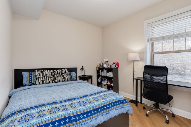 5331 S Harper Ave Unit 1, Chicago, IL 60615 - bedroom featuring baseboards, wood finished floors, and multiple windows
