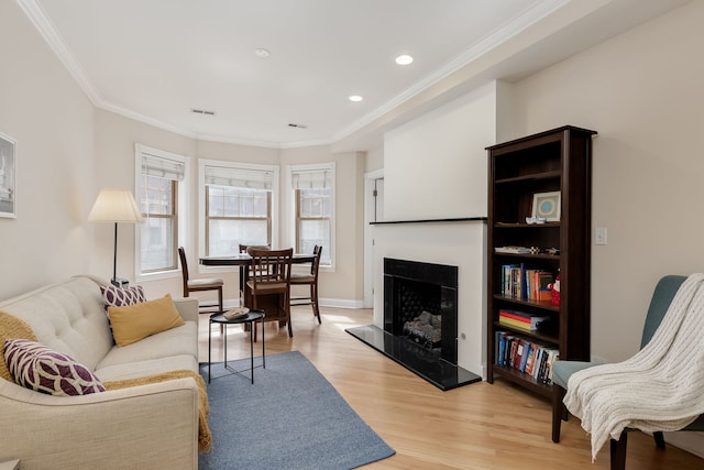 5331 S Harper Ave Unit 1, Chicago, IL 60615 - living area featuring recessed lighting, light wood-style floors, a fireplace with raised hearth, and crown molding