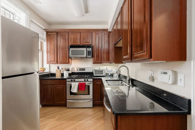 5331 S Harper Ave Unit 1, Chicago, IL 60615 - kitchen featuring stainless steel appliances, a toaster, a sink, dark stone counters, and light wood-style floors