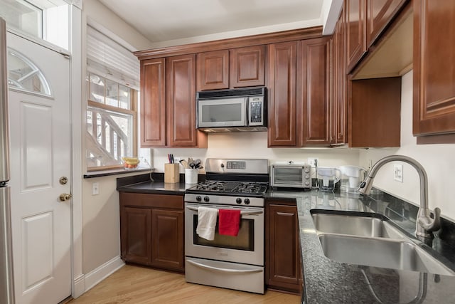 5331 S Harper Ave Unit 1, Chicago, IL 60615 - kitchen with a toaster, a sink, baseboards, light wood-style floors, and appliances with stainless steel finishes