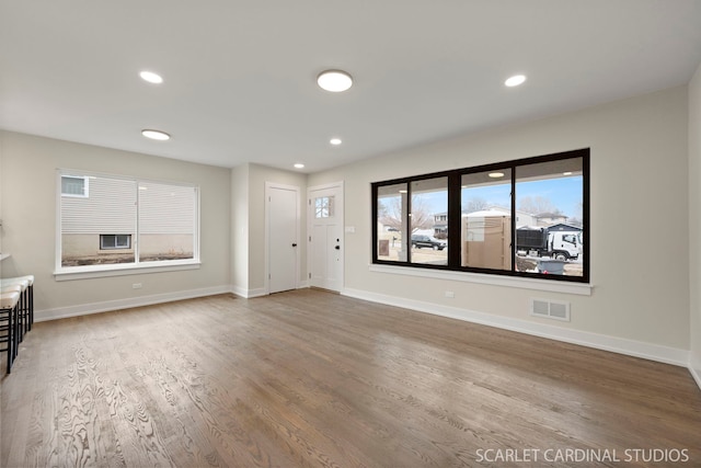 unfurnished living room with wood-type flooring