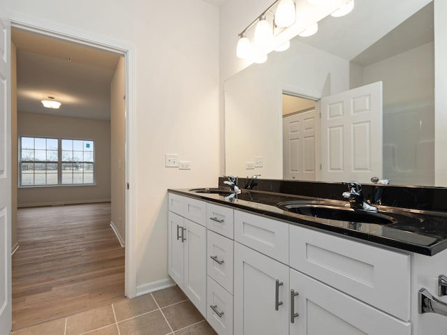 bathroom with vanity, a chandelier, and tile patterned flooring