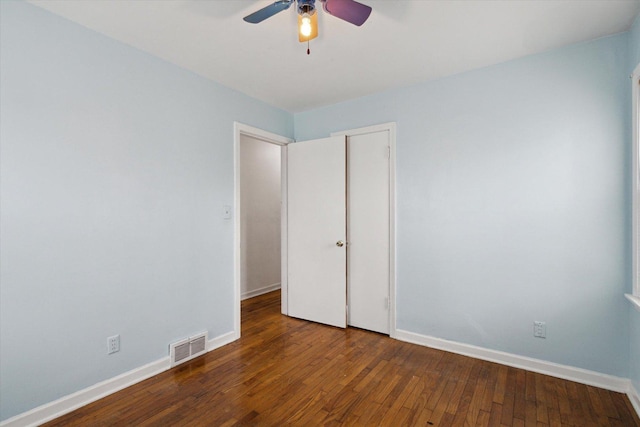 unfurnished bedroom with dark hardwood / wood-style flooring and ceiling fan