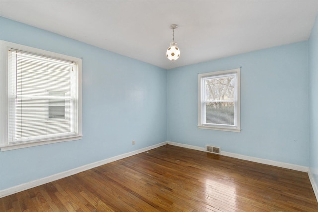 unfurnished room featuring dark wood-type flooring