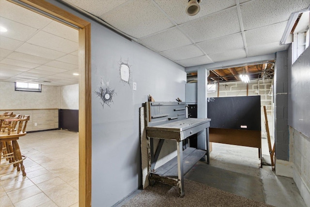 basement with a paneled ceiling