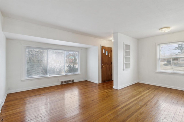 spare room featuring wood-type flooring