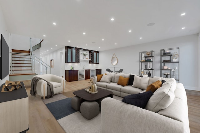 living room featuring bar, wine cooler, and light hardwood / wood-style floors