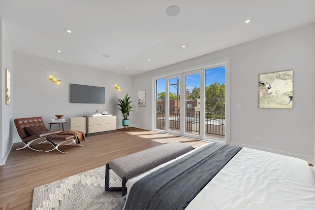 bedroom with access to exterior and light wood-type flooring