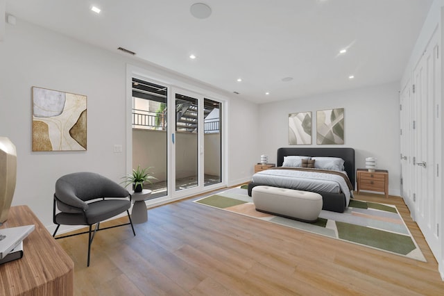 bedroom with access to outside and light hardwood / wood-style floors