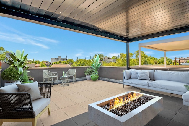 view of patio featuring an outdoor living space with a fire pit