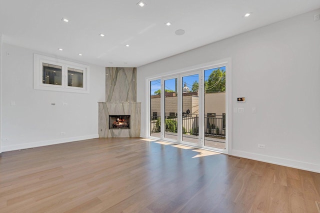 unfurnished living room featuring a fireplace and light wood-type flooring