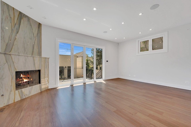 unfurnished living room featuring hardwood / wood-style floors and a fireplace