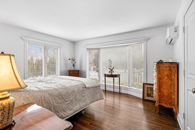 bedroom featuring multiple windows, a wall mounted AC, and dark hardwood / wood-style flooring