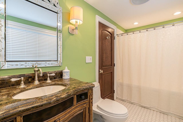 bathroom with vanity, toilet, and curtained shower