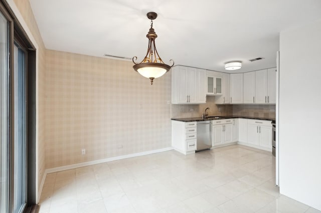 kitchen featuring baseboards, visible vents, wallpapered walls, white cabinets, and dishwasher