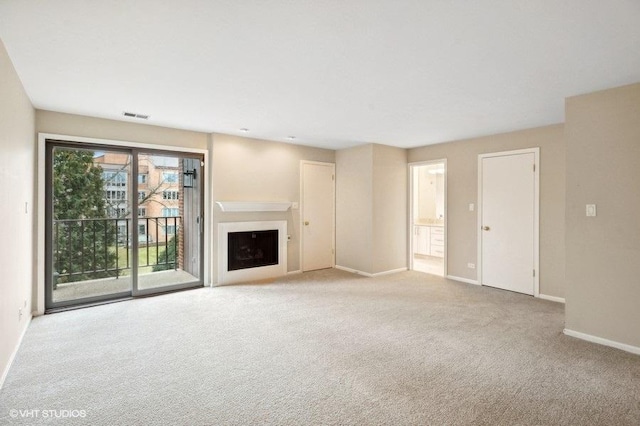 unfurnished living room featuring light carpet