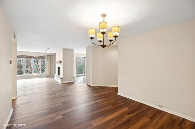 interior space with dark wood-type flooring and a notable chandelier