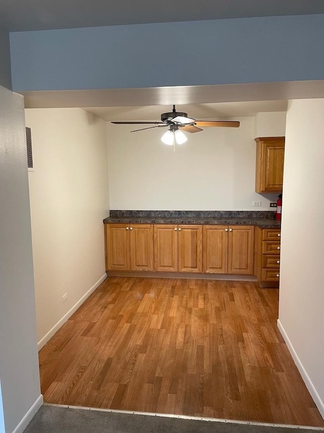 kitchen with light hardwood / wood-style flooring and ceiling fan