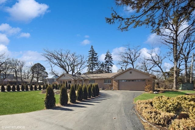 ranch-style home featuring a garage and a front yard