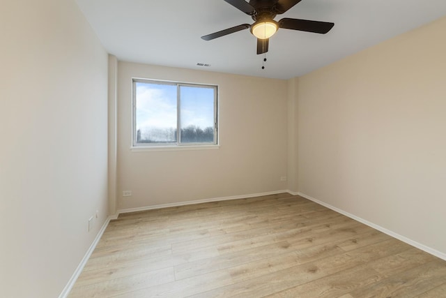 spare room with ceiling fan and light wood-type flooring