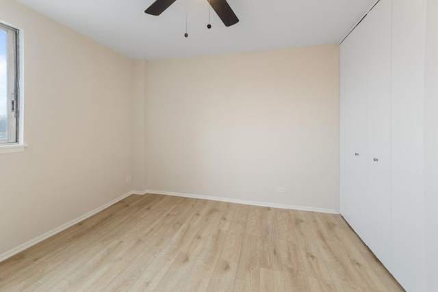 spare room with ceiling fan, a healthy amount of sunlight, and light hardwood / wood-style floors